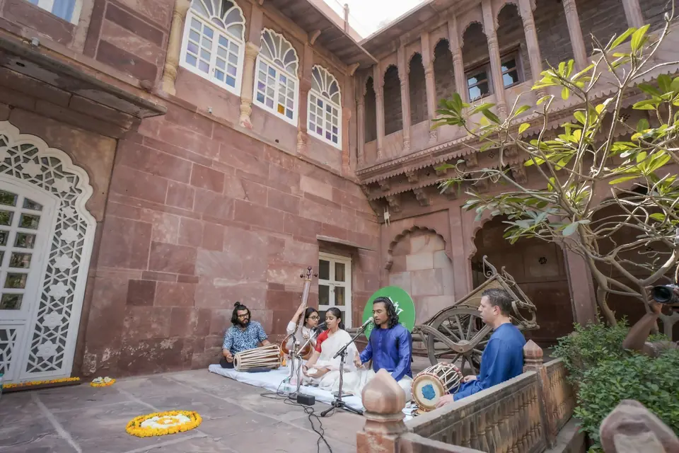 Musicians playing in a corner of the sandstone courtyard