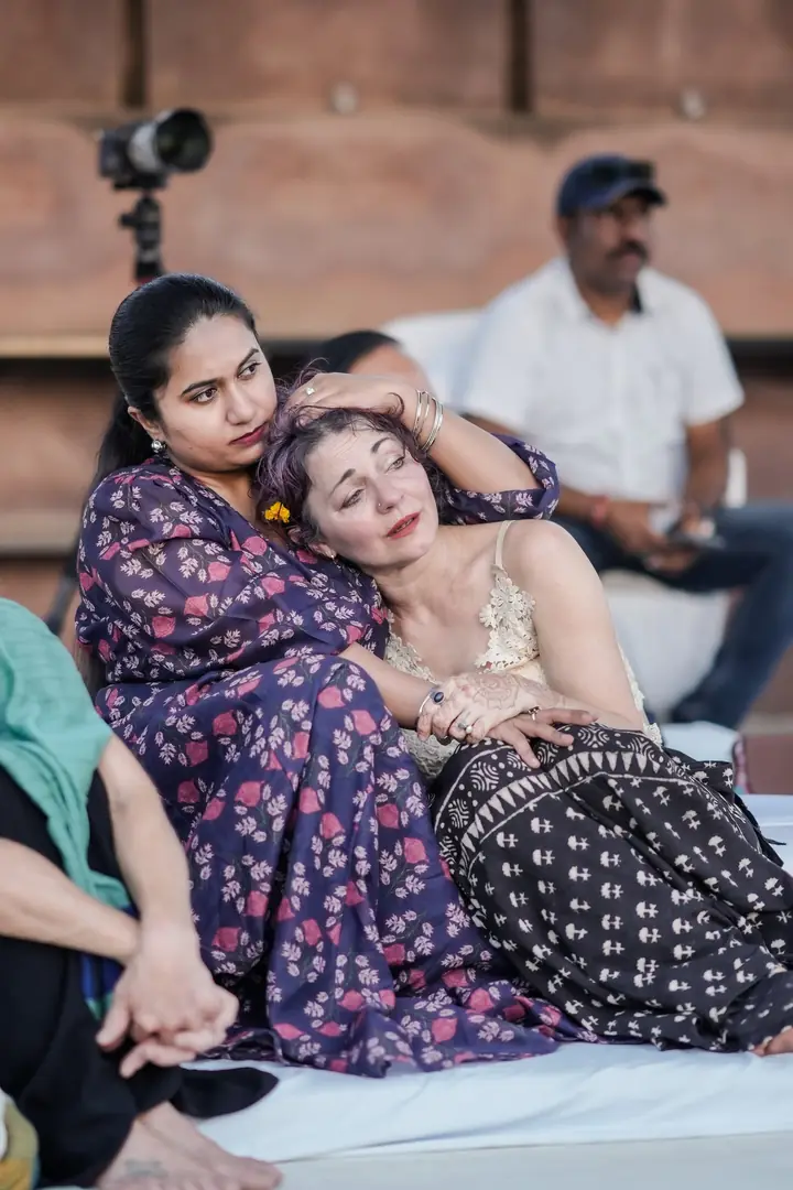 Two guests resting together on cushions