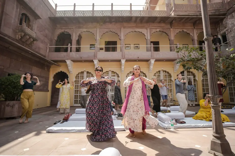 Guests learning kathak steps in the courtyard
