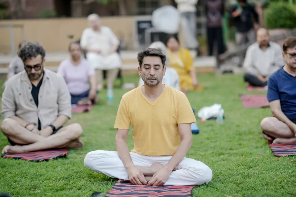 Guests seated cross-legged with eyes closed during morning naada yoga