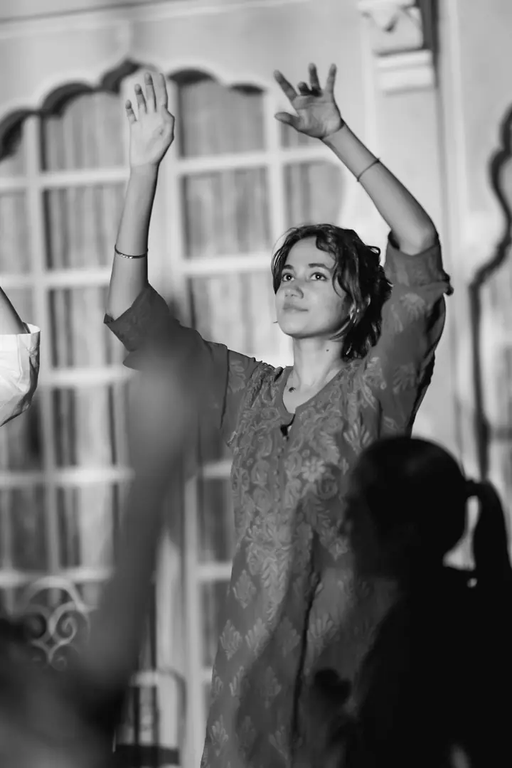 A guest dancing with both arms raised