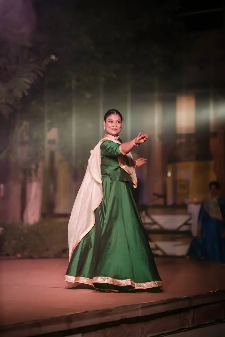 A kathak dancer in green on the main stage
