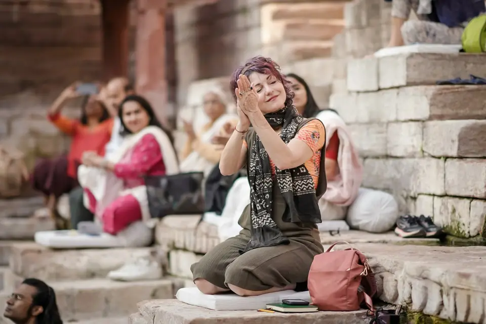 A guest singing along, eyes closed, hands raised