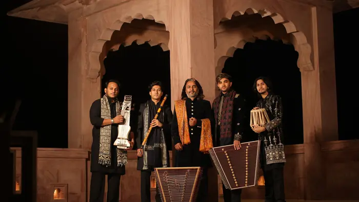 The Mantra with their instruments beneath the sandstone arches