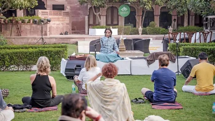 Ustad Nawab Khan leading morning naada yoga on the haveli lawn